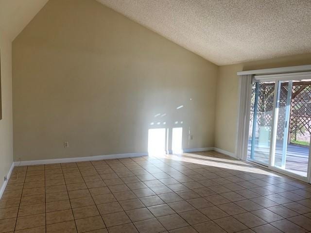 spare room featuring tile patterned floors, high vaulted ceiling, a textured ceiling, and baseboards