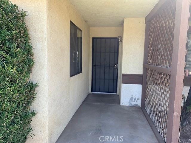 property entrance with stucco siding