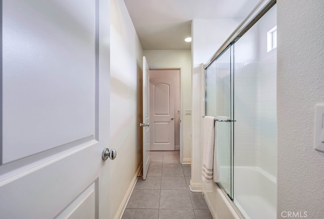 bathroom with tile patterned floors, enclosed tub / shower combo, and baseboards