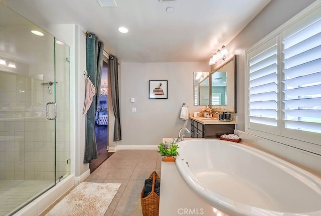 bathroom with tile patterned floors, a shower stall, vanity, and a garden tub