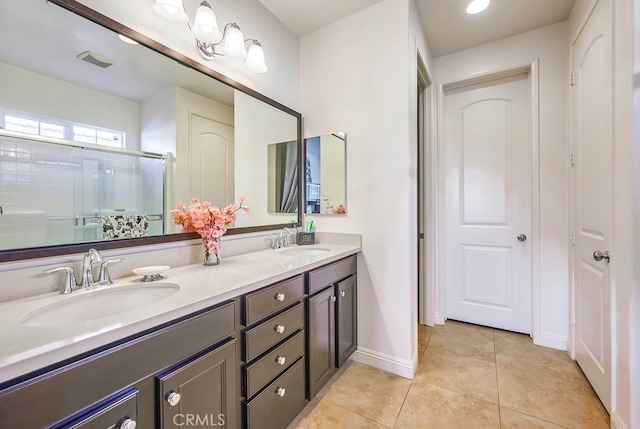 full bath with a sink, visible vents, a stall shower, and tile patterned flooring