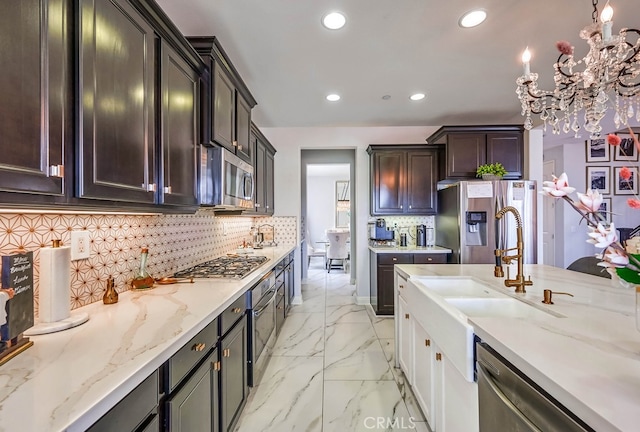 kitchen with light stone countertops, recessed lighting, a sink, stainless steel appliances, and marble finish floor