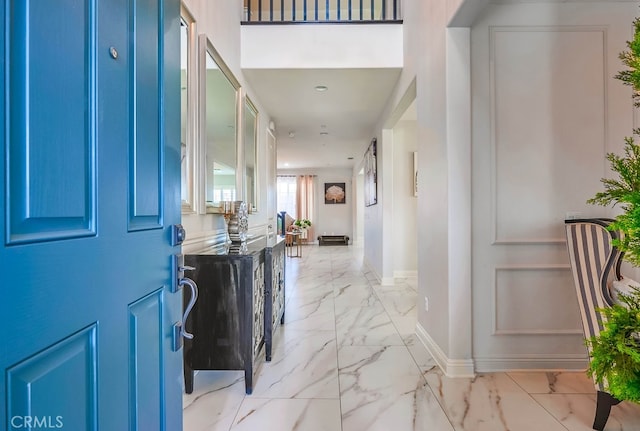 entrance foyer featuring recessed lighting, marble finish floor, and baseboards