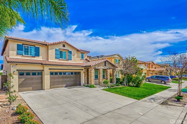 mediterranean / spanish-style home with a front lawn, a tile roof, stucco siding, driveway, and an attached garage