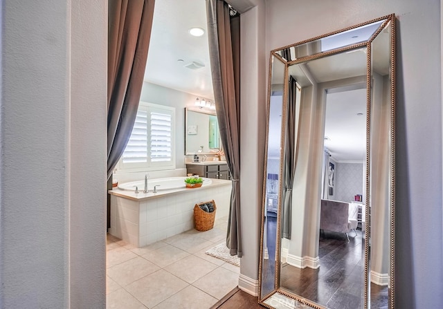 full bath with vanity, a garden tub, baseboards, and tile patterned floors