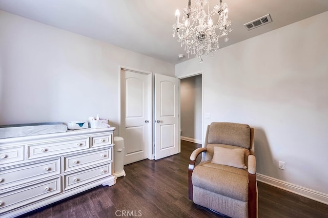 sitting room featuring visible vents, baseboards, dark wood-type flooring, and a notable chandelier