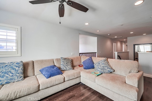 living area with dark wood-style floors and recessed lighting