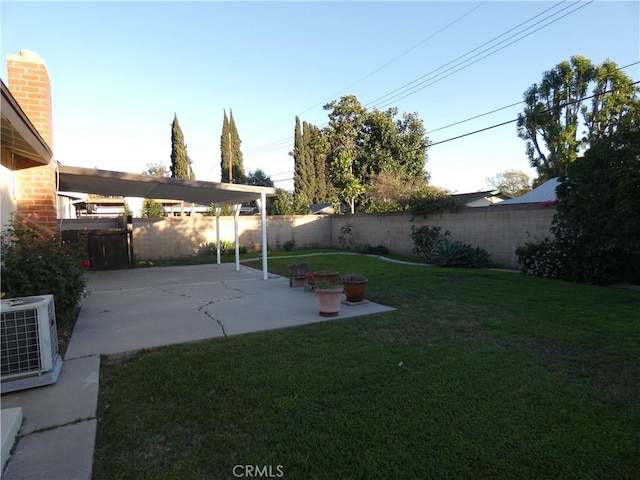 view of yard featuring a patio, central air condition unit, and a fenced backyard