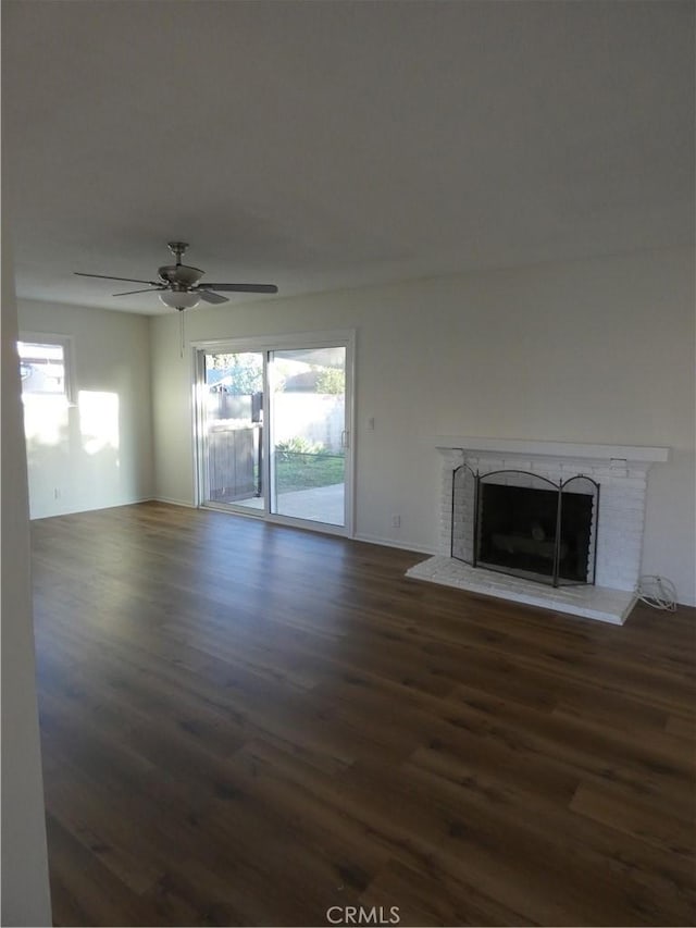 unfurnished living room with plenty of natural light, wood finished floors, and a fireplace