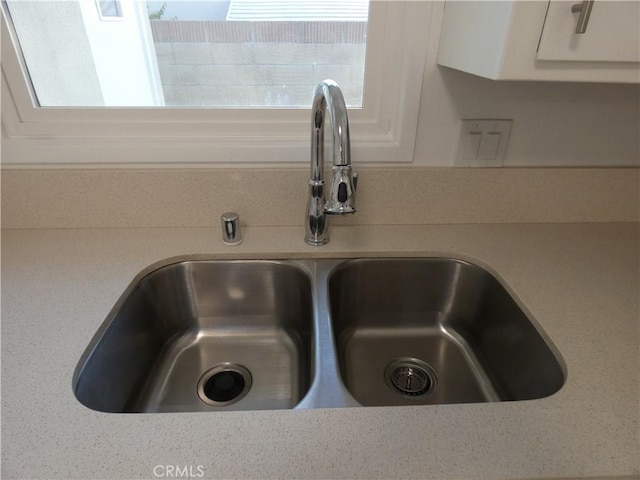 room details featuring light countertops and a sink