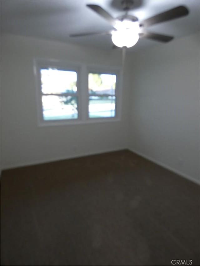 spare room with ceiling fan