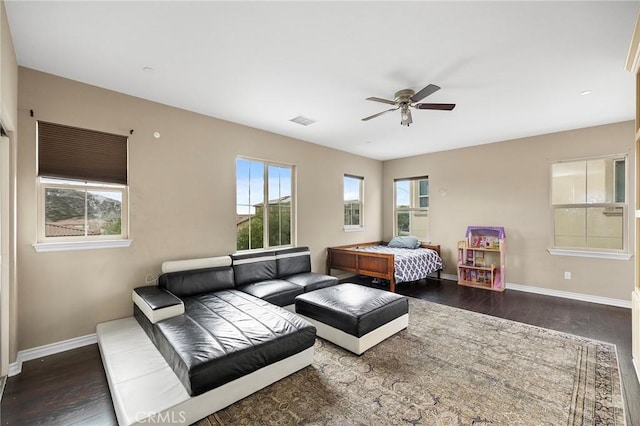 bedroom featuring visible vents, baseboards, and wood finished floors