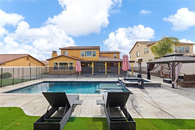 view of pool with a gazebo, a patio area, a pool with connected hot tub, and fence