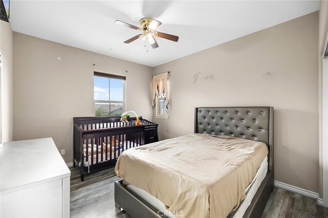 bedroom with wood finished floors, baseboards, and ceiling fan