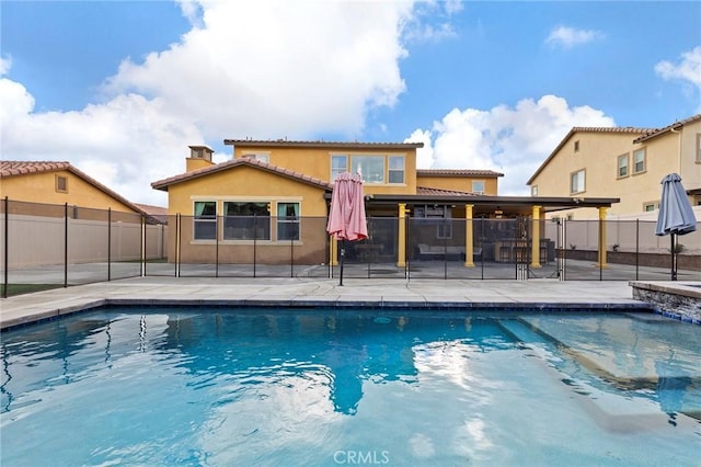 view of swimming pool featuring a fenced in pool, a patio area, and fence