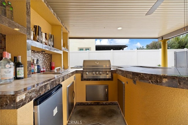 view of patio / terrace featuring a sink, grilling area, area for grilling, and fence