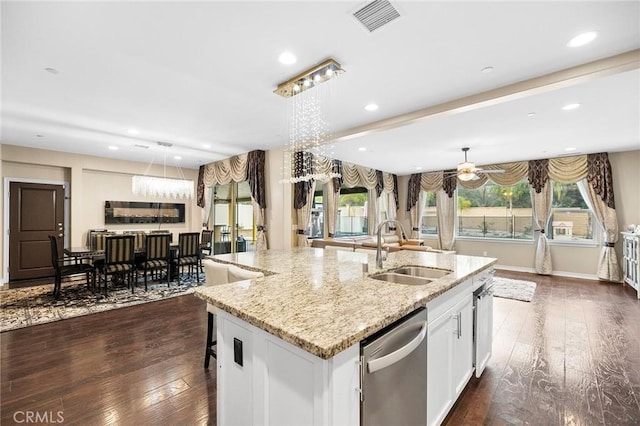 kitchen featuring visible vents, dark wood finished floors, an island with sink, a sink, and stainless steel dishwasher