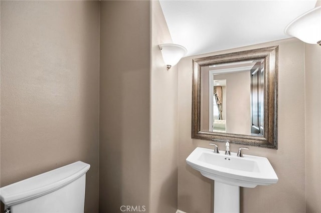 bathroom with toilet and a sink