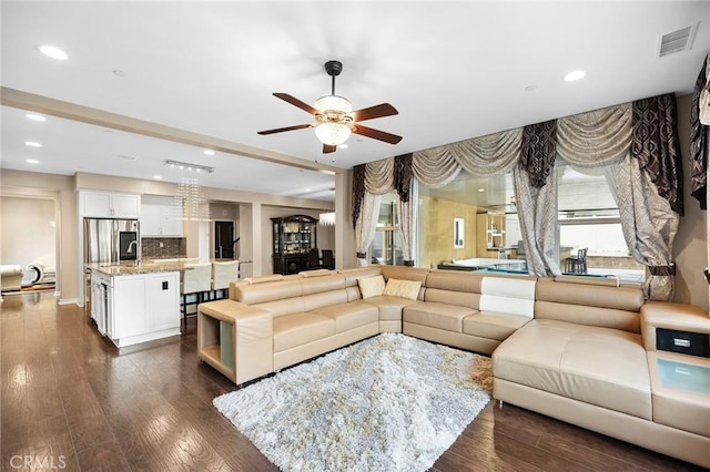 living room with recessed lighting, visible vents, dark wood-style flooring, and ceiling fan