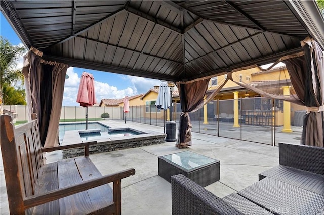 view of patio / terrace with a gazebo, a pool with connected hot tub, and a fenced backyard