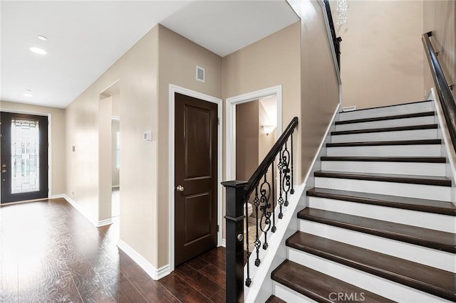 entryway with visible vents, dark wood-style floors, recessed lighting, stairway, and baseboards