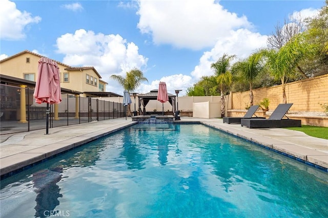 view of swimming pool featuring a gazebo, a patio area, a pool with connected hot tub, and a fenced backyard