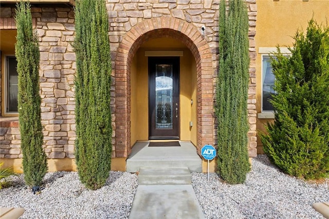 property entrance with stone siding