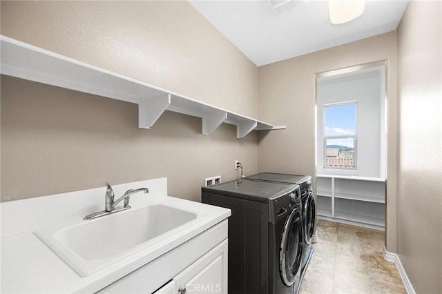 laundry area featuring cabinet space, independent washer and dryer, baseboards, and a sink