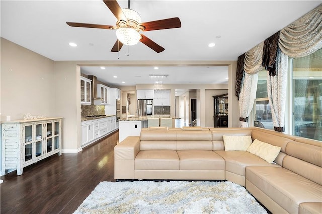 living area featuring recessed lighting and dark wood-style flooring