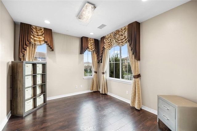 empty room with recessed lighting, visible vents, baseboards, and dark wood finished floors