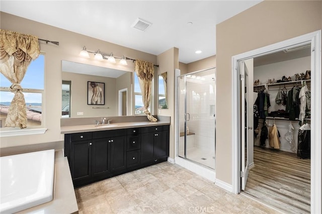 full bath with a spacious closet, visible vents, a stall shower, and vanity