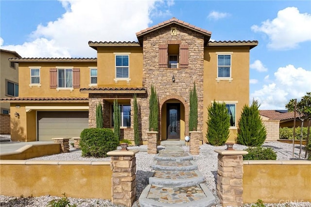 mediterranean / spanish-style home with concrete driveway, a garage, stone siding, and stucco siding