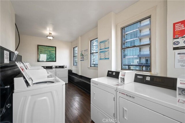 shared laundry area with independent washer and dryer and dark wood-style flooring