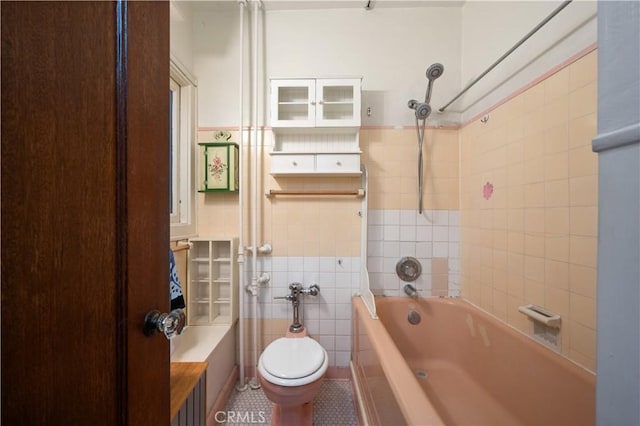 full bathroom featuring shower / bathing tub combination, toilet, tile walls, and tile patterned flooring