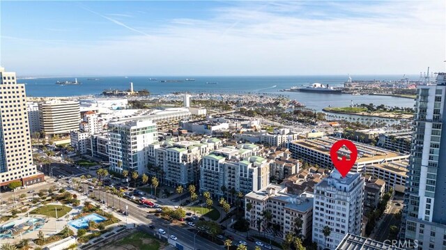 birds eye view of property featuring a city view and a water view