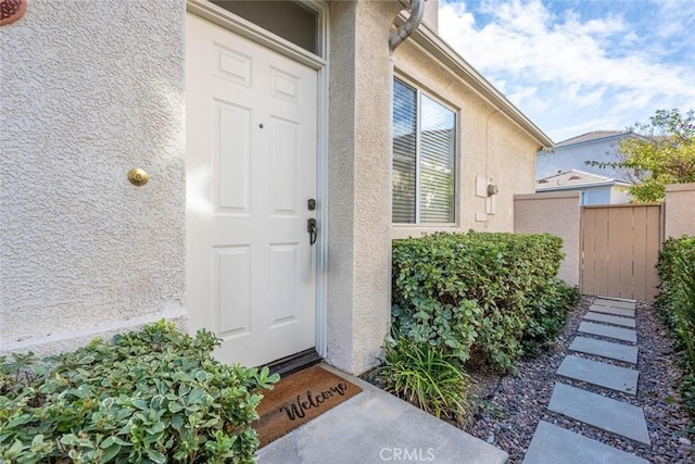 property entrance featuring stucco siding