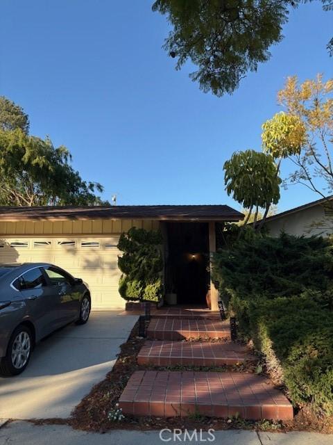 exterior space with board and batten siding and driveway