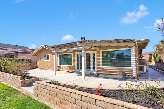 12899 Rain Shadow Rd, Victorville, CA 92395 - back of house with a patio area, stucco siding, and a pergola