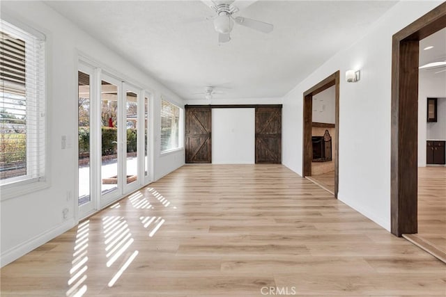 12899 Rain Shadow Rd, Victorville, CA 92395 - unfurnished sunroom with a barn door and ceiling fan