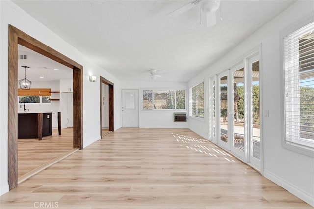 12899 Rain Shadow Rd, Victorville, CA 92395 - unfurnished sunroom with a wall unit AC, visible vents, and ceiling fan