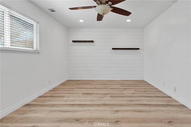 12899 Rain Shadow Rd, Victorville, CA 92395 - spare room featuring light wood-style flooring, wooden walls, recessed lighting, and visible vents