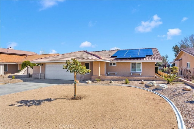 12899 Rain Shadow Rd, Victorville, CA 92395 - ranch-style house featuring solar panels, concrete driveway, fence, and stucco siding