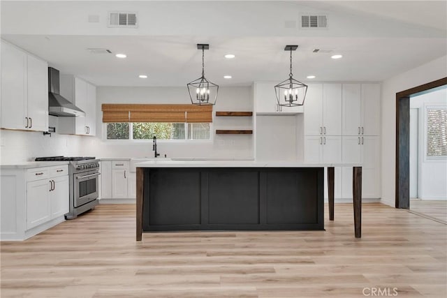 12899 Rain Shadow Rd, Victorville, CA 92395 - kitchen with high end range, visible vents, a center island, and wall chimney range hood
