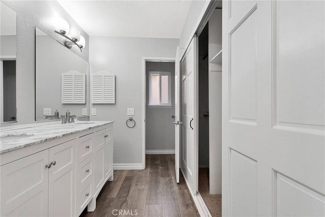 12899 Rain Shadow Rd, Victorville, CA 92395 - full bath with a sink, baseboards, wood finished floors, and double vanity
