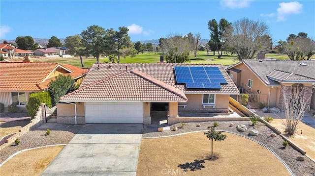 12899 Rain Shadow Rd, Victorville, CA 92395 - view of front facade with stucco siding, solar panels, concrete driveway, and a tile roof