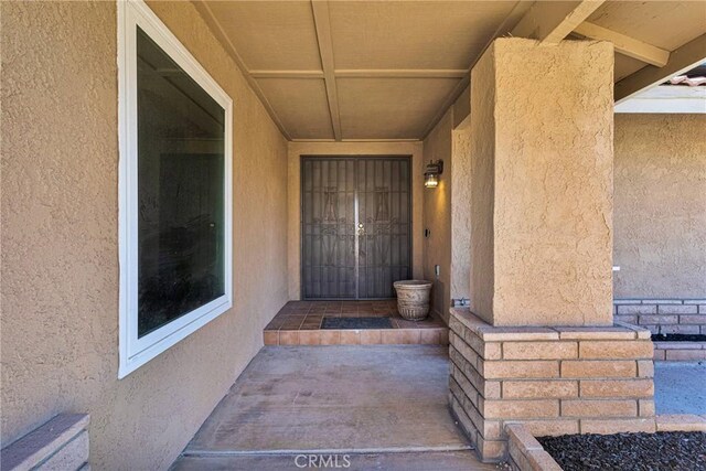 12899 Rain Shadow Rd, Victorville, CA 92395 - doorway to property with stucco siding