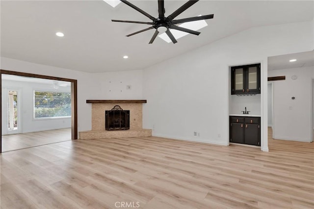 12899 Rain Shadow Rd, Victorville, CA 92395 - unfurnished living room with lofted ceiling, a fireplace, light wood finished floors, and ceiling fan