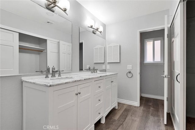 12899 Rain Shadow Rd, Victorville, CA 92395 - bathroom with a sink, visible vents, wood finished floors, and double vanity