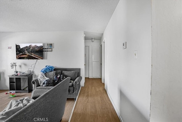 living room with wood finished floors and a textured ceiling