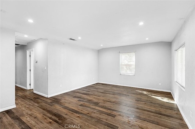 empty room with hardwood / wood-style flooring, recessed lighting, and visible vents